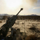Marines with 1st Battalion, 11th Marine Regiment, 1st Marine Division, fire an M777 howitzer during Exercise Desert Scimitar 2015 aboard Marine Corps Air Ground Combat Center Twentynine Palms, California, April 7, 2015. – United States Marine Corps